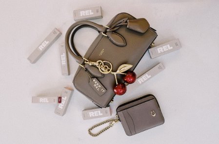 REL Beauty Giveaway – Win A Coach Satchel Bag, Cherry Bag Charm, & More